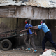 A police officer pushes a man trying to cross a police checkpoint, after the government announced a two weeks lockdown of the neighbourhood of Eastleigh, Nairobi, Kenya May 7, 2020.